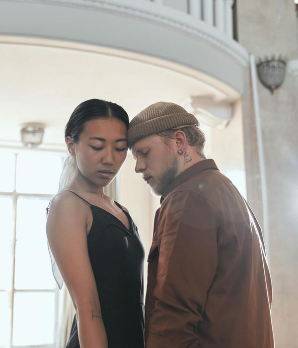 Woman performing a fluid, gentle movement in a bright room.